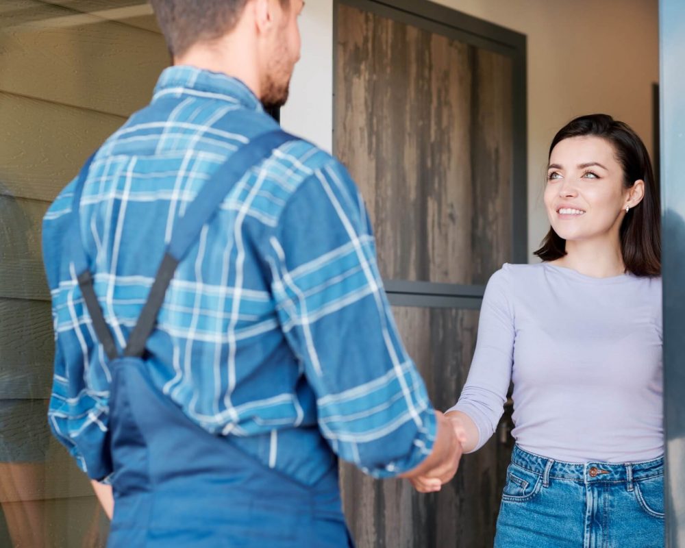 happy-young-client-of-maintenance-service-shaking-hand-of-technician.jpg
